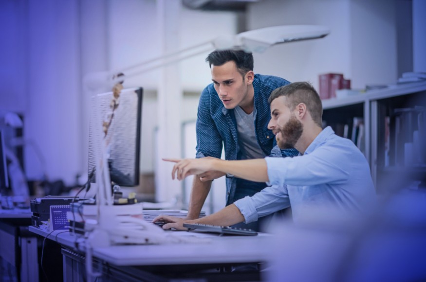 Two people using a computer