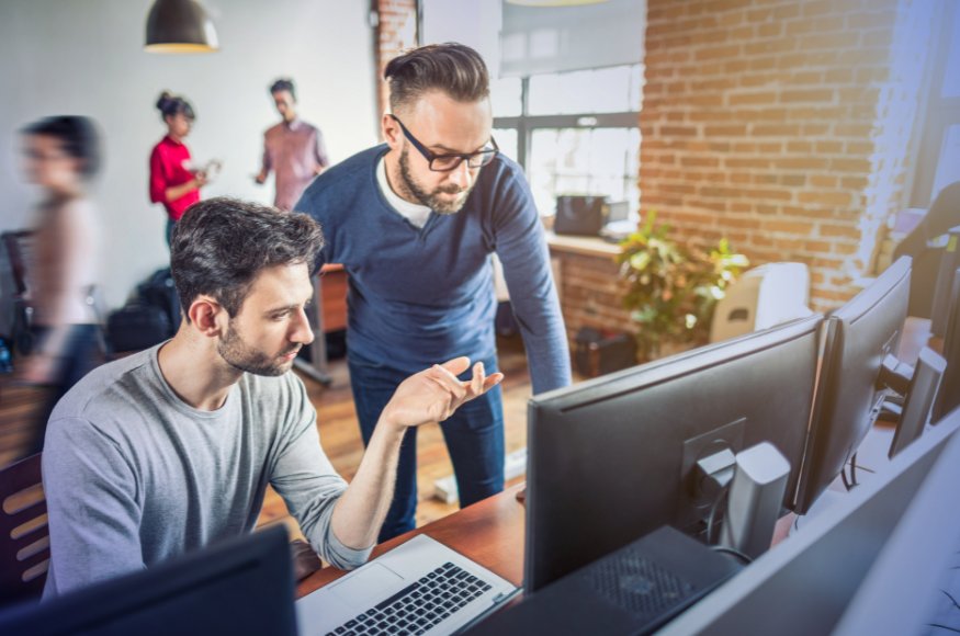 Two men looking at a monitor